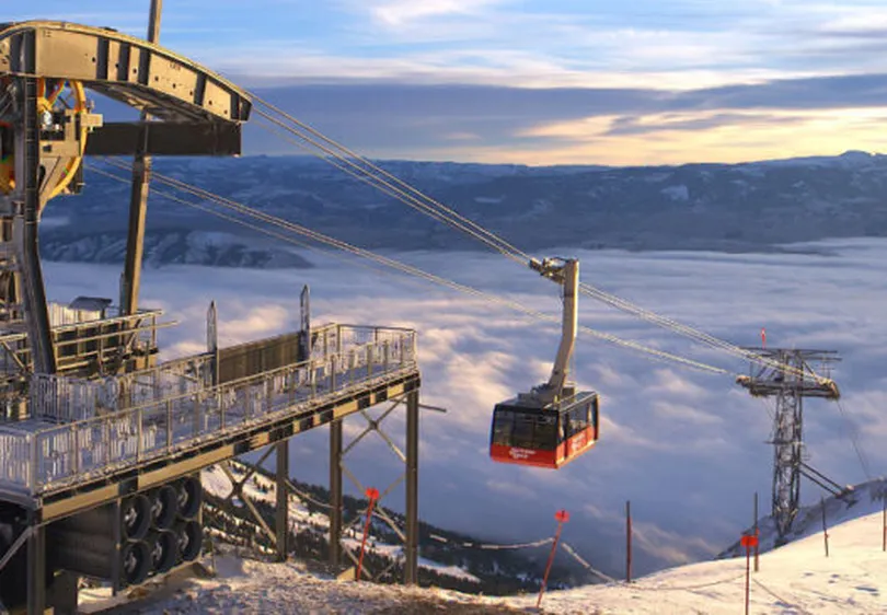 Jackson Hole's iconic red cable car travels above the clouds to top station