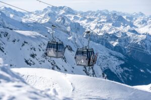 Roche de Mio Gondola cabins transporting skiers high above La Plagne’s alpine terrain.