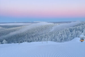 a pink sunset over a ski area