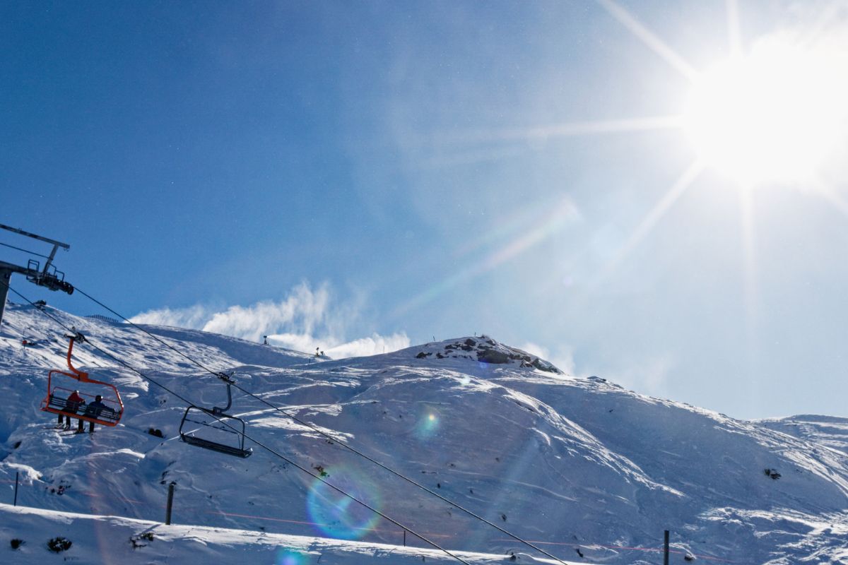 Sunny ski slopes and chairlift at Treble Cone ski area, Wānaka, New Zealand