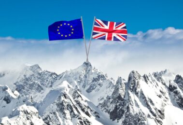 EU and UK flags crossed over snowy Alpine mountains