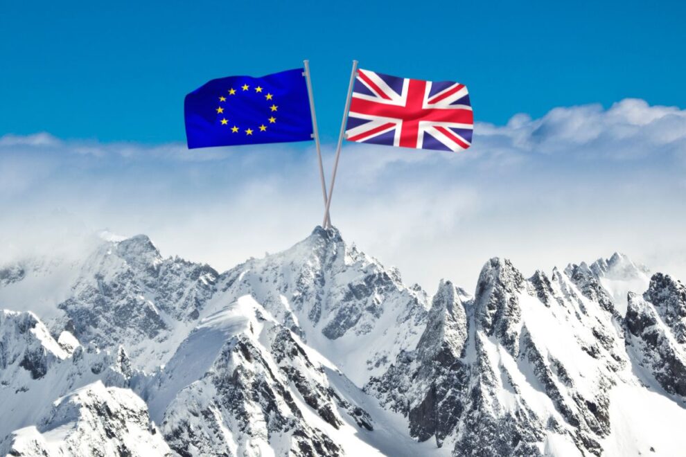 EU and UK flags crossed over snowy Alpine mountains