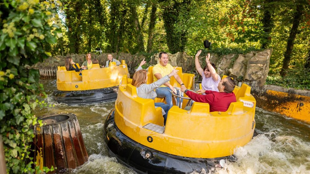 Families on yellow river rapids ride at Walibi Rhône-Alpes Alpine theme park