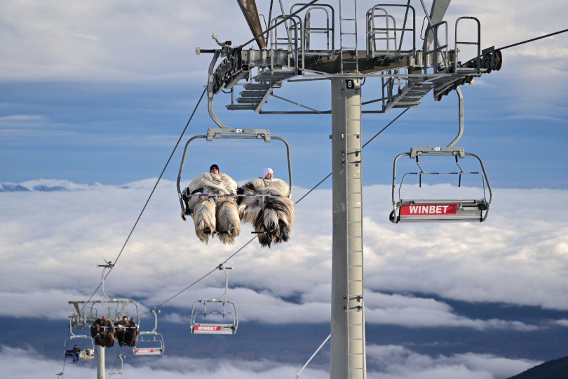 yetis sat on a chairlift