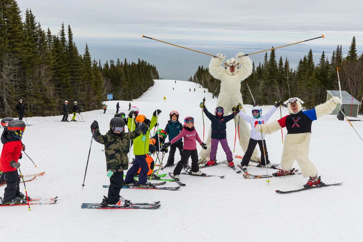 ski instructors dressed up as yetis with their group of kids