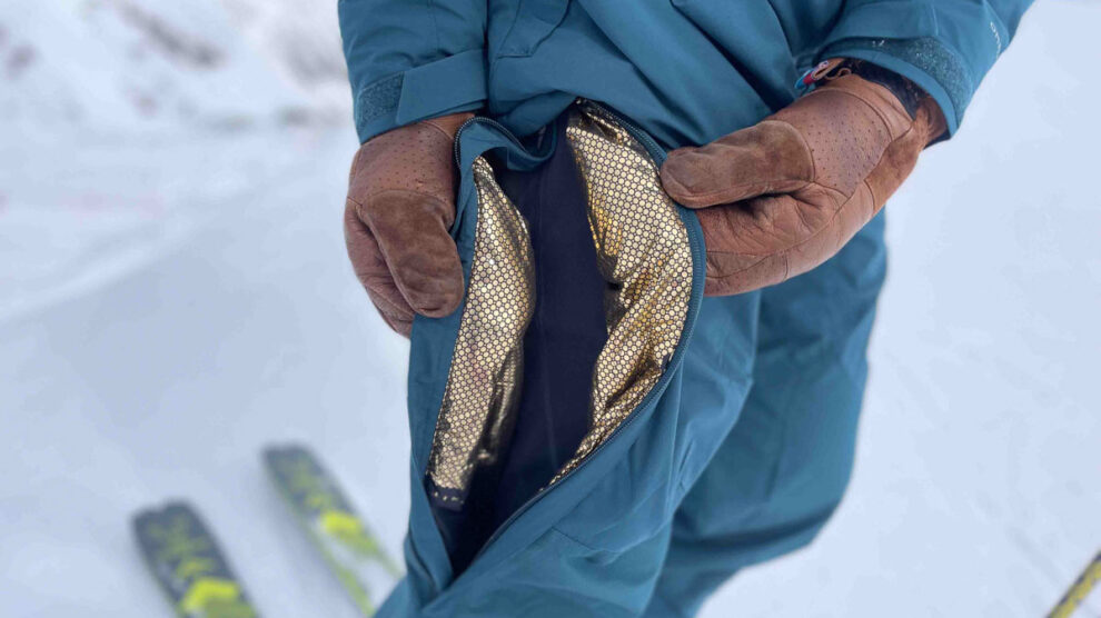 gold lining of ski gear, shown through side zip of ski pants