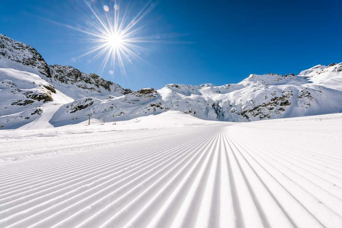 perfect corduroy piste with a shining sun and blue sky