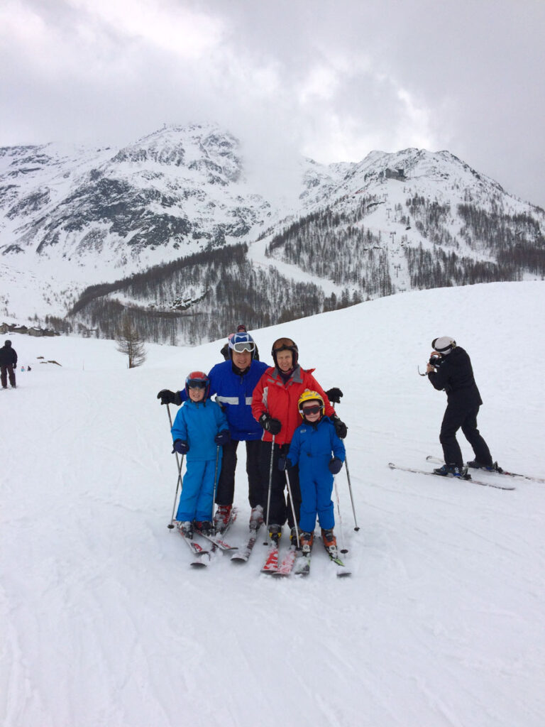 family ski photo on a moody day on the mountain, with two kids