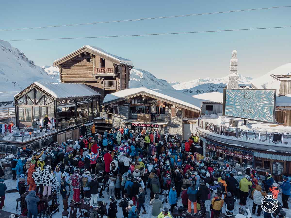 crowd of people outside the Folie Douce building for apres ski on the mountain in Val d'Isere