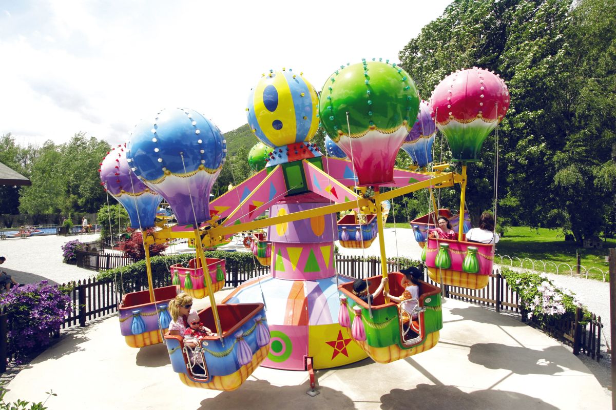 Colourful balloon ride for kids at Happyland Alpine theme park in Valais Switzerland