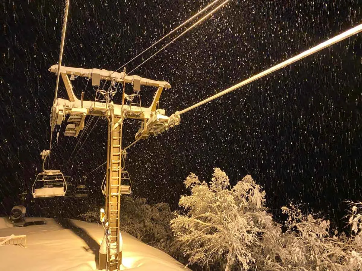 a chairlift shot at night under snow