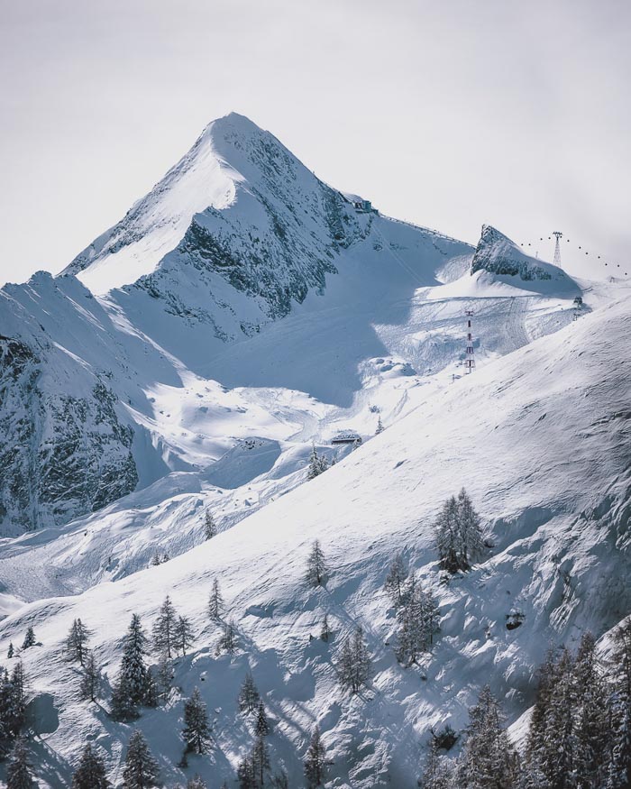 scene of a snowy Maiskogel März by Kitzsteinhorn taken from a different mountain