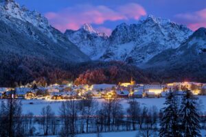 The village of Kranjska Gora in Slovenia under a dusky sky tinged with pink