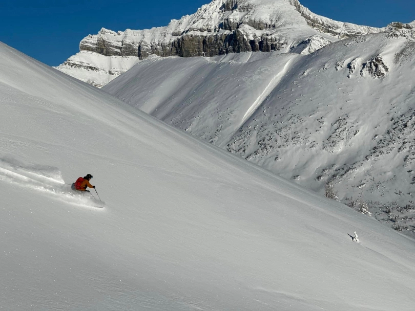 A lone skier makes fresh tracks off piste