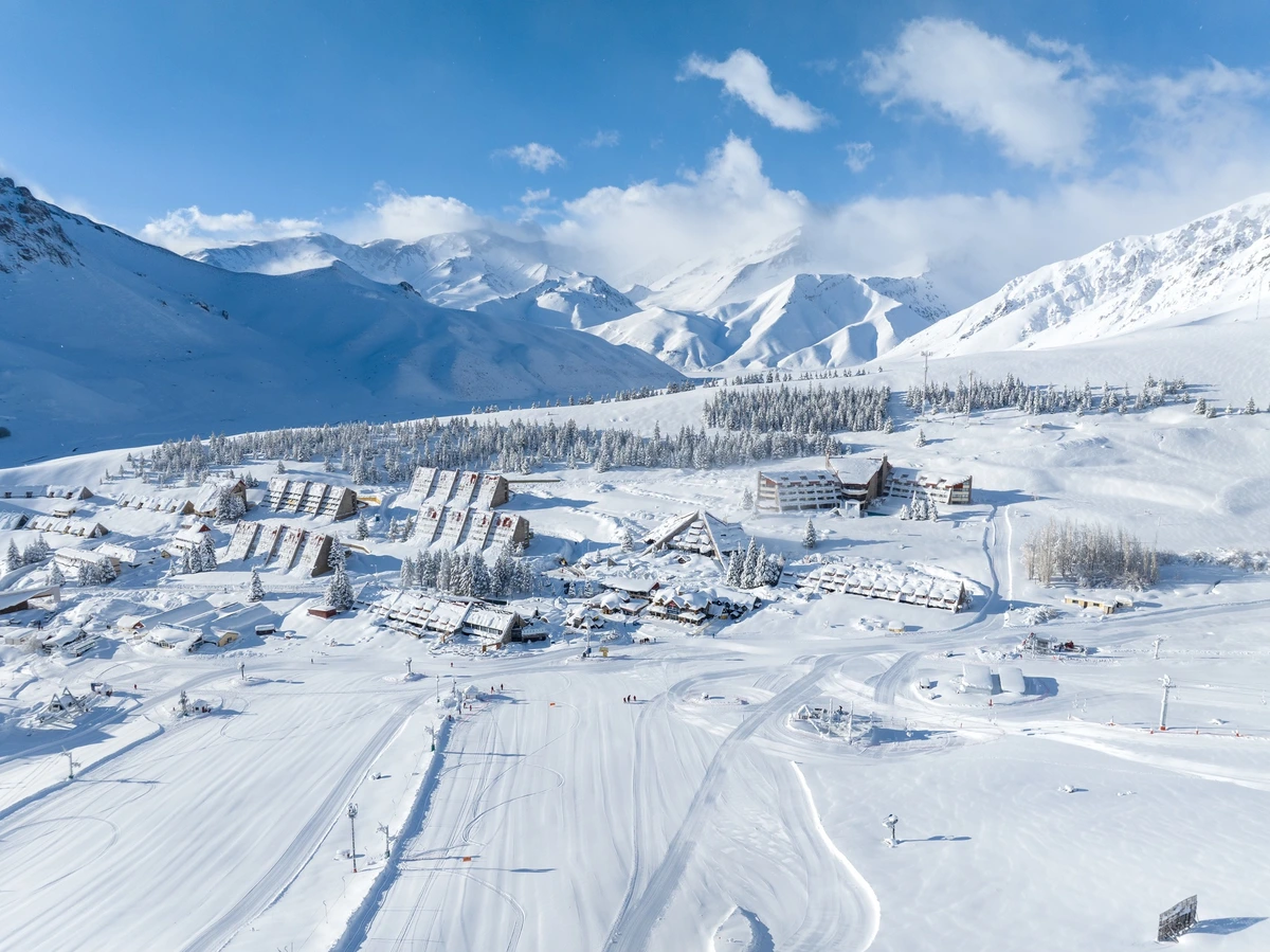 high-altitude ski resort Las Lenas is photographed, surrounded by snow on a plateau, high mountains in the background