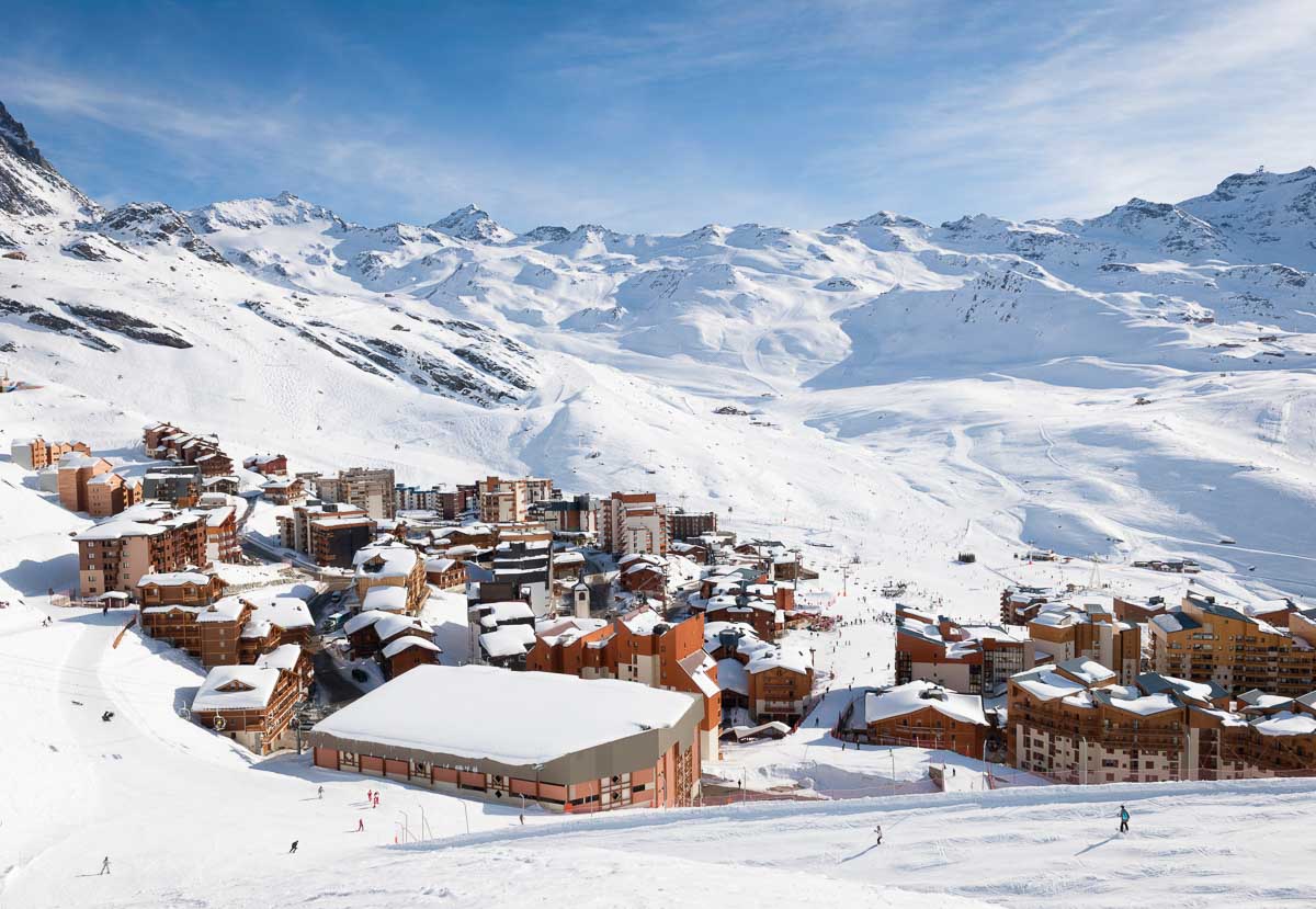 People skiing on the pisted slopes around the town of Val Thorens, one of the resorts within the Trois Vallees ski area.