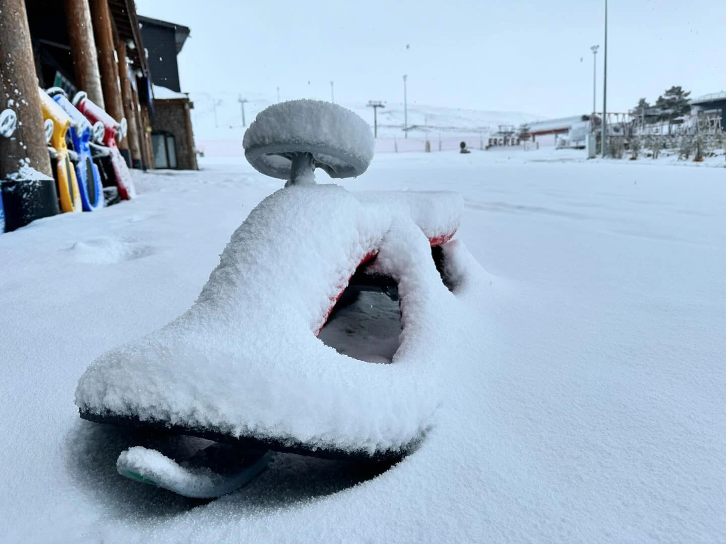 a baby's sled is covered by an inch of fresh snow
