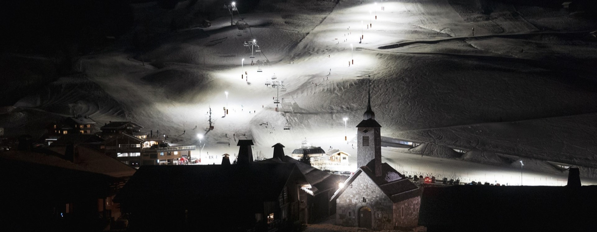a ski slope lit up at night for night skiing