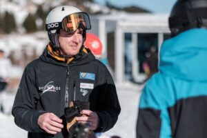 English-speaking ski instructor from SnowPros talking to a skier