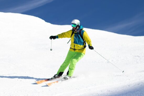 A skier moments after a stem turn, showing the transition phase and areas for improvement in skiing posture