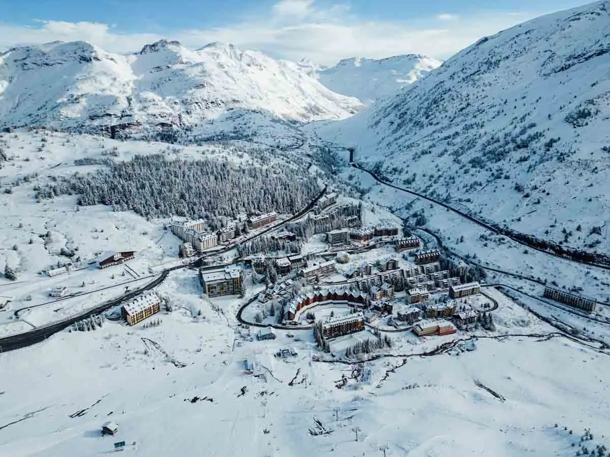 a snow covered mountain town is pictured from the sky