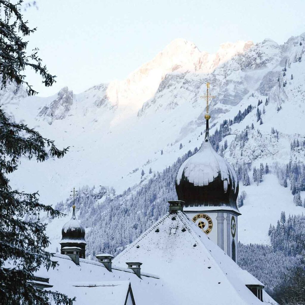 a very Swiss church steeply dusted in snow