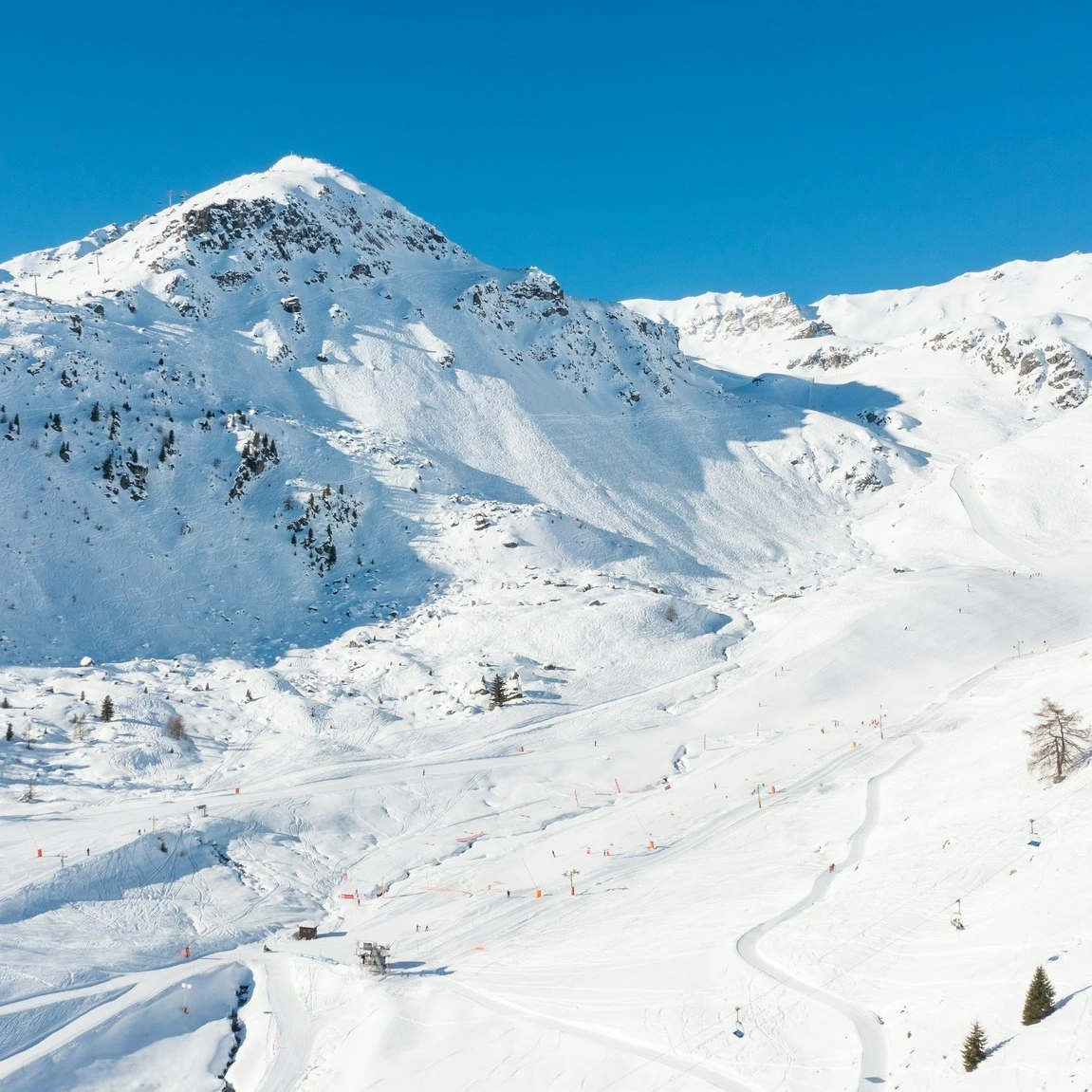 a white ski area, pistes looking beautiful, with tracks all over the off-piste terrain