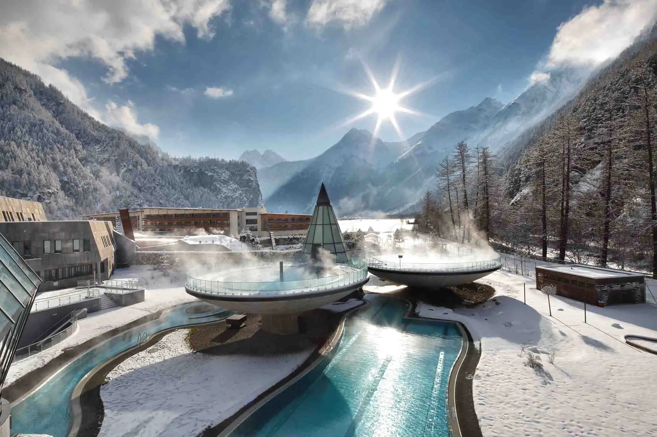 an outside spa, with steaming waters, in a snowy mountain valley