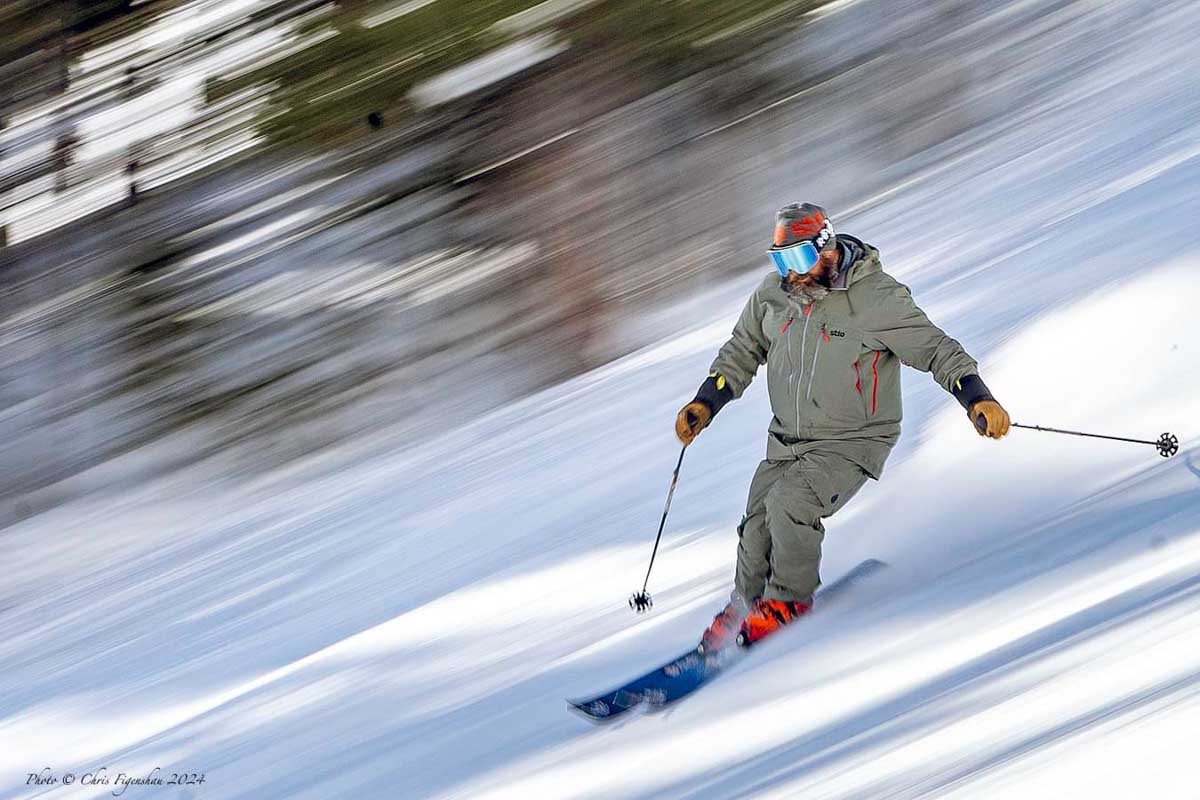 a skier perfectly in focus, the whole snowy slope and background a blur, as if he's travelling at the speed of light