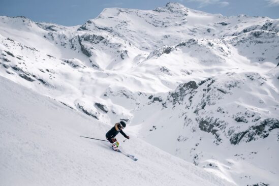 Skier gliding through deep powder snow on an off-piste run in Val d'Isère.