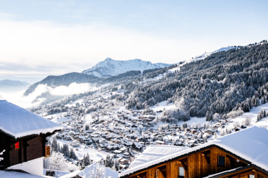 the snow-covered village of les Gets, taken from a hill behind a wooden chalet above the town